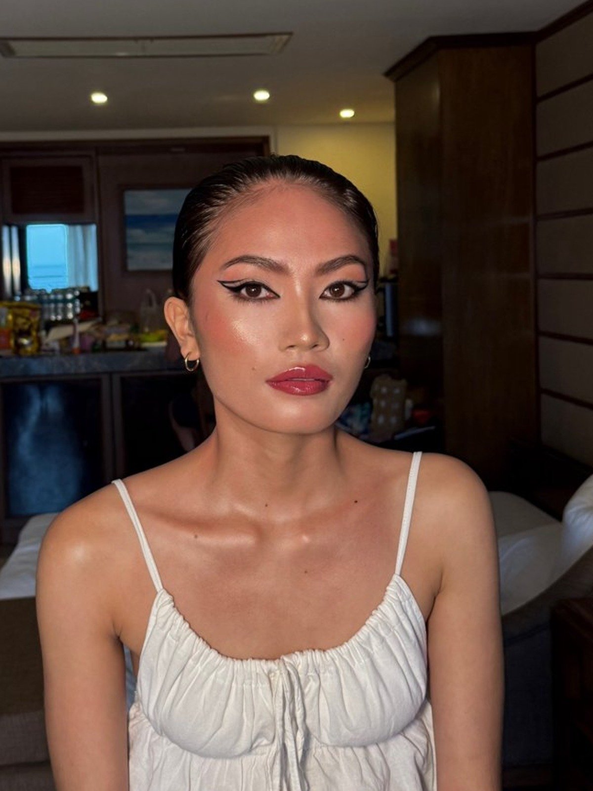 Beauty close-up — graphic double-flick liner, coral blush, glossy red lip